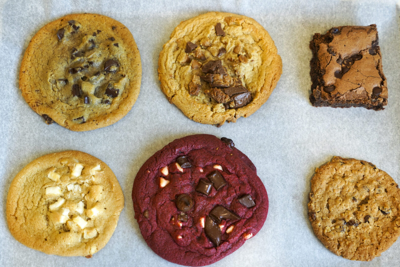 A variety of cookies are shown on the tray.